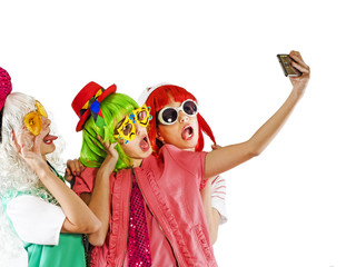 Three women in a party clothes do selfie. Isolated on white
