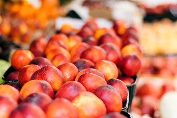 Fresh juicy fruits on the market, ripe peaches