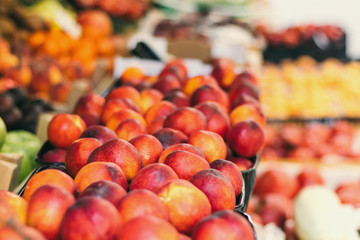 Fresh juicy fruits on the market, ripe peaches