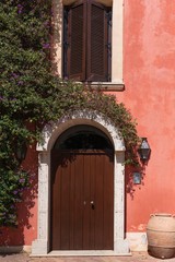 Beautiful door decorated with flowers in italian farm house