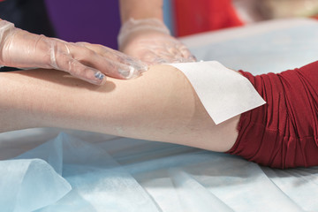 Process depilation female legs and knee in a beauty salon