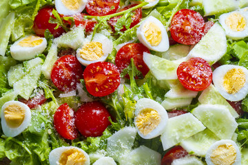 Salad with lettuce, cherry tomatoes, cucumber and quail eggs