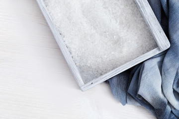 Crystals of white sea salt in blue wooden box with cotton cloth. Spa background. Spa concept. Sea salt for bath.