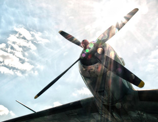 Wing and propeller plane against the sky and sun