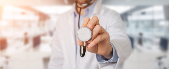 Doctor using stethoscope in hospital