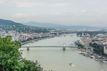 Obraz premium Budapest in rainy and fog day waterfront urban city district scape from above top of hill with mountain on horizon view 