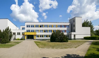 Public school building. Exterior view of school building with playground. © Saulius