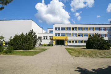 Public school building. Exterior view of school building with playground. © Saulius