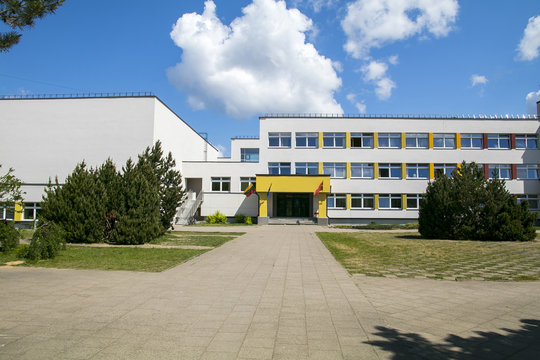 Public School Building. Exterior View Of School Building With Playground.
