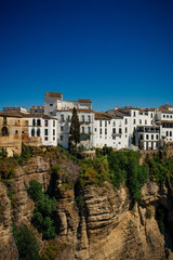 Fototapeta na wymiar White houses on the edge of a cliff in Ronda, Andalusia, Spain.
