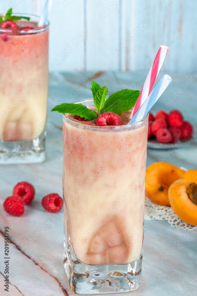 Sticker Peach and raspberry melba smoothie garnished with fresh fruit and mint