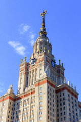 Tower of Lomonosov Moscow State University (MSU) with star on the spire on a blue sky background