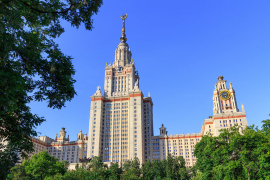 Lomonosov Moscow State University (MSU) in sunny summer evening on a green trees background