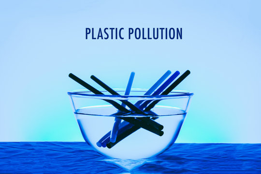 Plastic pollution title in the ocean concept photo with glass of bowl and plastic straw blue color effect