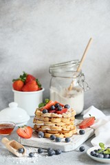 Waffles with fresh seasonal berries and whipped cream. 