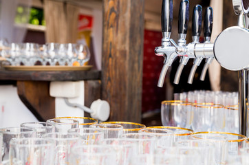 glasses for beer and a beer faucet on the summer terrace