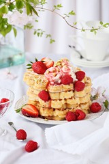Waffles with fresh seasonal berries and whipped cream. 