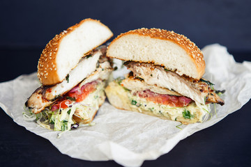 Fishburger cut in two parts on the black background