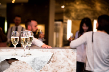 the waiter offers guests champagne