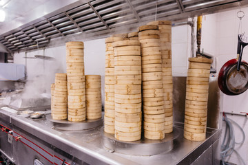 Piles of stacking bamboo steamers are steaming for dim sum.