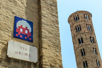 A mosaic from a modern street artist Invader on an old wall in Ravenna, Italy