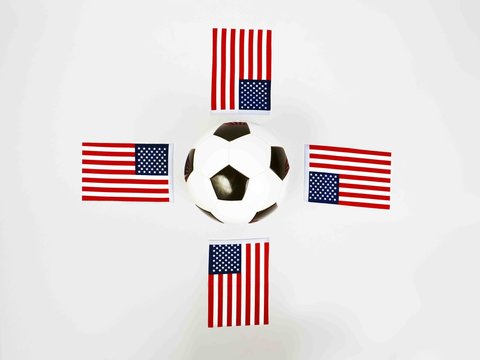 vintage black and white football ball surrounded by national flags of united states of america