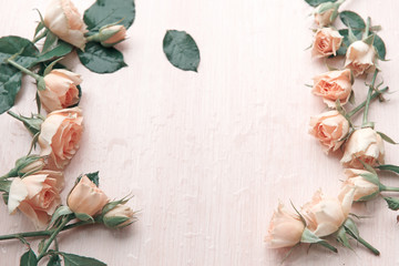 several pink roses on a wooden background
