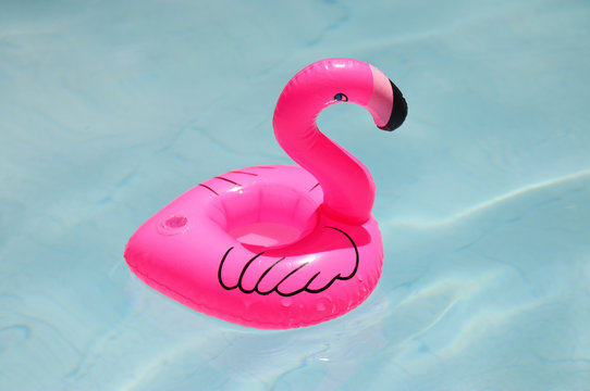 inflatable pink flamingo in swimming pool.