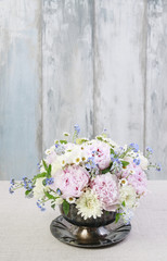 Floral arrangement with pink peonies, ranunculus flowers, white chrysanthemums, matricaria forget...