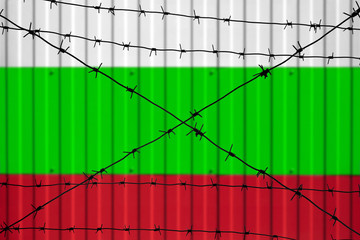 National flag of Bulgaria on fence. Barbed wire in the foreground symbolizes entry ban or prohibition for crossing border of country