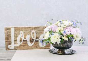 Floral arrangement with pink peonies, ranunculus flowers, white chrysanthemums, matricaria forget...