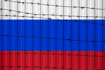 National flag of Russia on fence. Barbed wire in the foreground symbolizes entry ban or prohibition for crossing border of country