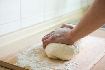 Hands kneading a dough.