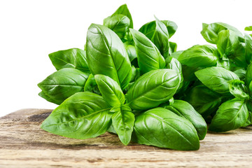 Fototapeta premium Basil leaves on wooden table.