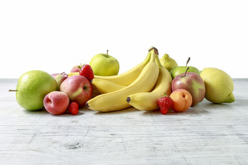 Stack of fruits on wooden table.