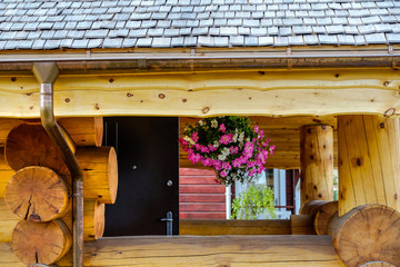 Natural wooden tiles made of larch. Wooden shingles is a unique coating and beautiful roofing and facade material.