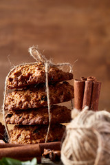 Christmas composition with oatmeal, chocolate biscuits, and spices, on wooden background, close-up, selective focus.