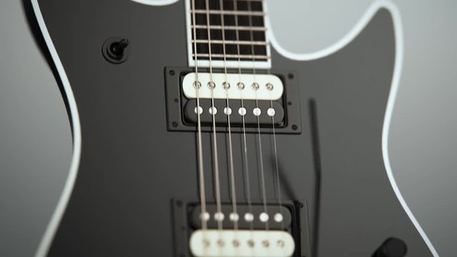 Modern six-string electric guitar on a concrete. Contemporary music instrument.