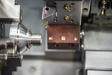 The CNC lathe or turning machine cutting the thread at cone shape part.Hi-technology manufacturing process.