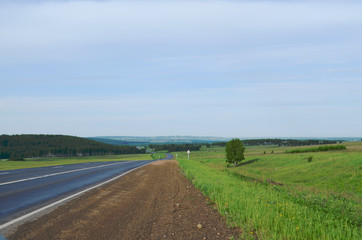 Fototapeta na wymiar Landscape road receding into the distance