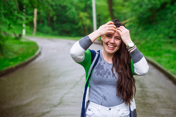 portrait of young adult woman wet after rain. smiling