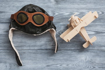 helmet and plane on wooden background