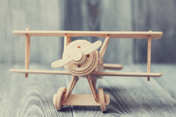 toy airplane on wooden gray background in vintage style