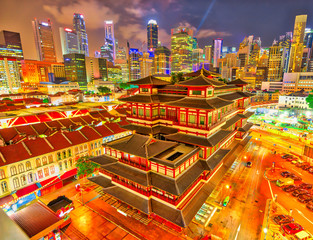 Buddha Tooth Relic Temple of Singapore from aerial view, Southeast Asia. Spectacular buddhist temple in Chinatown district with business district skyline on background by night.