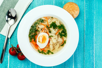 chicken soup, noodles, home cooking, blue wood background, egg