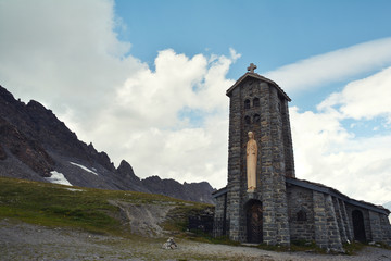 Fototapeta na wymiar Stone church at Col de l'Iseran mountain pass in France, the highest paved pass in the Alps,part of the Graian Alps, in the department of Savoie.