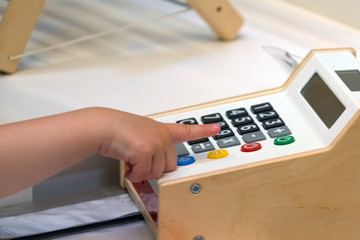 Childrens calculator. The child learns to count on an electronic calculator.