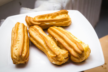 Homemade eclairs on a white plate