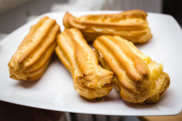 Homemade eclairs on a white plate