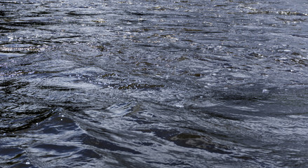 background - river water with waves and whirlpools on a cloudy day